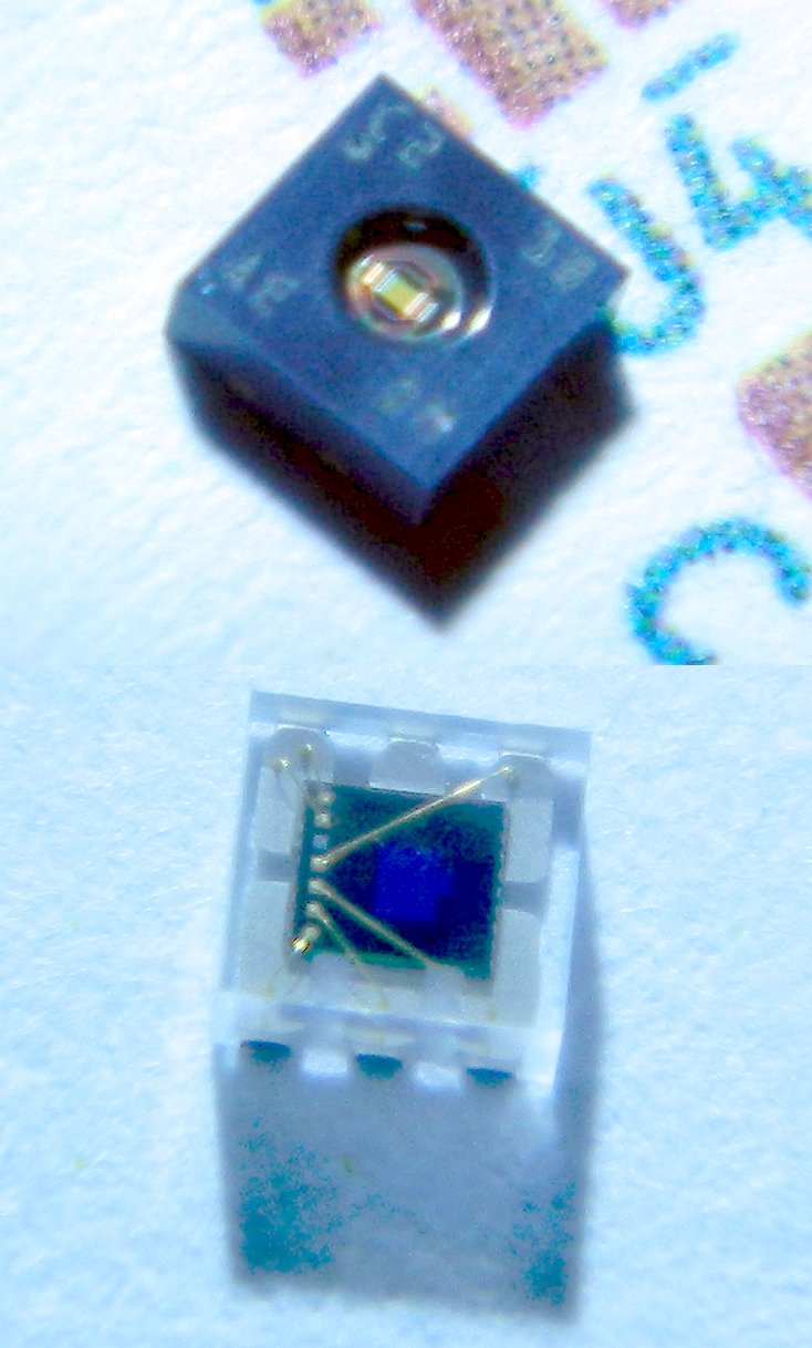 Photos of small environmental sensing ICs.  They appear as small boxes, some transparent like glass with wires inside, others solid black with a small window